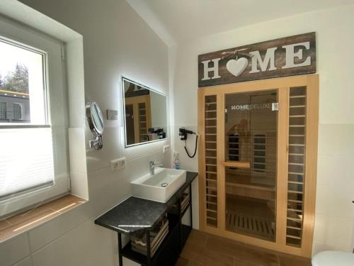 a bathroom with a sink and a window at Ferienhaus Bimmelbahn 2 in Olbersdorf