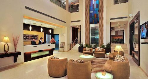 a large living room with couches and chairs in a building at Best Western Maryland in Chandīgarh