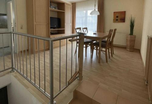 a dining room and kitchen with a table and chairs at Haus Kiek Ut Apartment 22 in Timmendorfer Strand