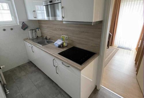 a kitchen with a sink and a counter top at Haus Kiek Ut Apartment 22 in Timmendorfer Strand