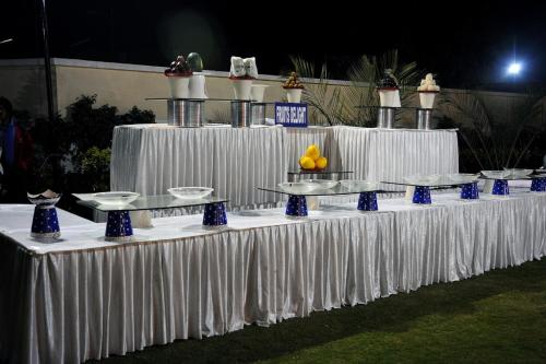 a long table with white tables with food on it at Best Western Maryland in Chandīgarh