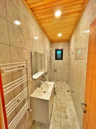 a bathroom with a sink and a mirror at Şahin Home in Uzungöl