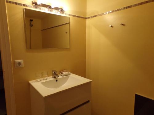 a bathroom with a sink and a mirror at Hotel Roc de St Miquel & Apartment in Soldeu