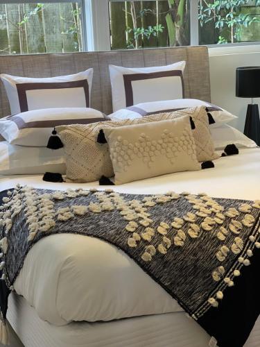 a bedroom with two beds with pillows at Absolute Beach in Mount Maunganui