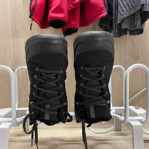 a pair of black boots hanging on a rack at Jeseníky Apartmán číslo 5 in Nové Losiny