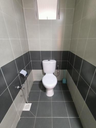 a bathroom with a white toilet in a stall at Dream 3 @ Emerald avenue in Brinchang