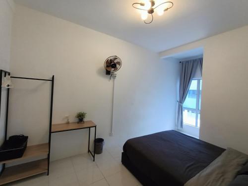 a bedroom with a bed and a fan and a window at Dream 3 @ Emerald avenue in Brinchang