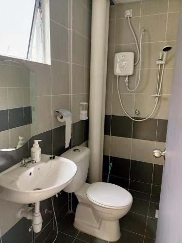 a bathroom with a toilet and a sink and a shower at Dream 3 @ Emerald avenue in Brinchang