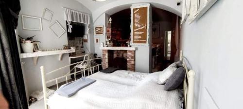 ein Schlafzimmer mit einem Bett in einem kleinen Zimmer in der Unterkunft Godot Apartman in Miskolc