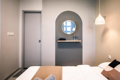 a bedroom with a bed and a mirror at Jesselton Quay by Pinstay in Kota Kinabalu