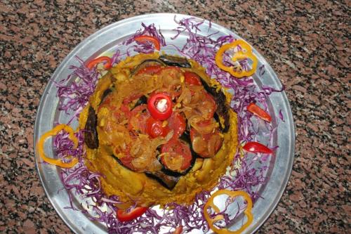 a glass plate with a dish of food on a table at Happy Camp in Nuweiba
