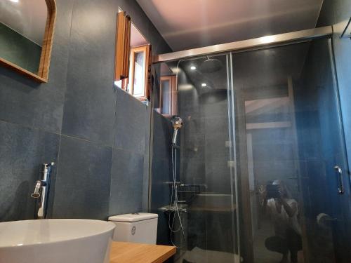 a bathroom with a shower and a toilet and a sink at Athina Apartments in Stoupa