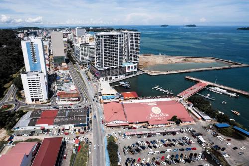 an aerial view of a city with a harbor at Jesselton Quay by Pinstay in Kota Kinabalu