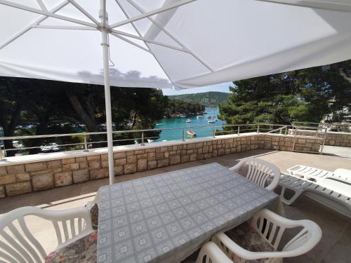 a patio with a table and chairs and an umbrella at Apartment Portofino in Primošten