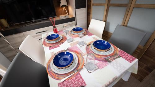 a table with plates and bowls on top of it at Apartamentos Formigal - admite mascotas in Formigal