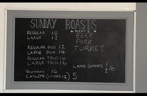 a chalkboard with the words sunday roast written on it at J2 static caravan at Fairway Holiday Park in Sandown