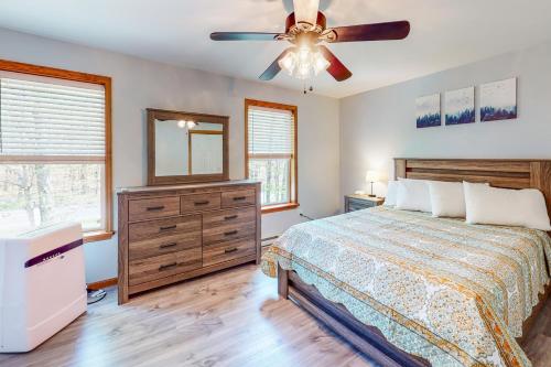 a bedroom with a bed and a ceiling fan at Penn Forest Paradise in Albrightsville