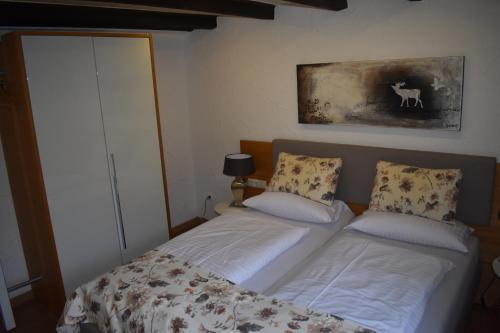 a bedroom with two beds and a painting on the wall at Hotel & Gastropark Loemühle in Marl