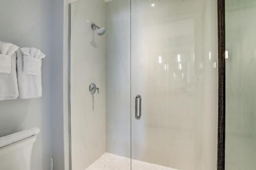 a shower with a glass door in a bathroom at The Heart of Naples in Naples
