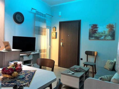 a living room with a couch and a table at Renovated flat in the heart of Karditsa in Kardítsa
