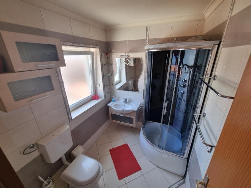 a bathroom with a shower and a toilet and a sink at Guesthouse Franica in Korčula