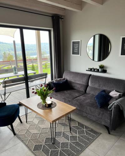 a living room with a couch and a table at Przystanek Patulskie in Pierszczewo