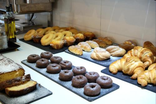 a bunch of different types of breads and pastries at Hotel Zenit Pamplona in Cordovilla