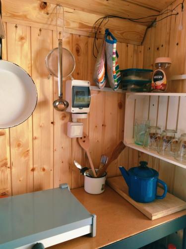 a kitchen with wooden walls and a counter top at Maringotka Ivetka in Luže