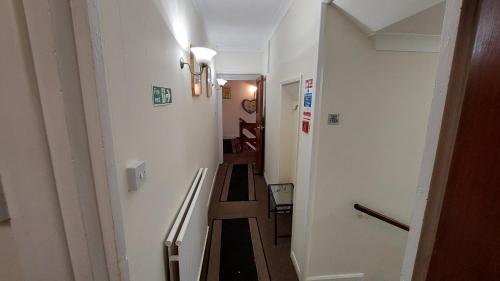 a hallway with a stairway leading to a room at Tennyson Lodge in Mablethorpe