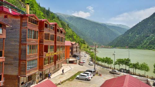a view of a town with a river and mountains at Uzungol Doga Grand Otel in Uzungol