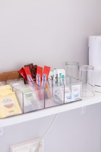 a shelf with toothbrushes and other items on it at La Solana Montañesa in Comillas