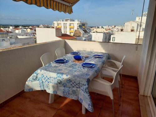 Una mesa en un balcón con vista a una ciudad. en À da Mamé - Monte Gordo, en Monte Gordo