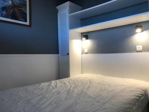 - une chambre dotée d'un lit avec deux lumières dans l'établissement Sympathique appartement en bord d'océan, à Lacanau
