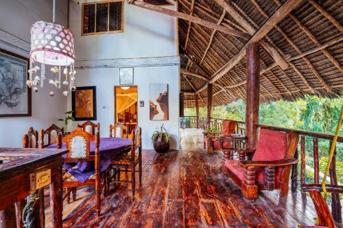 a dining room with a table and chairs at Utupoa in Matemwe