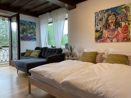 a living room with a bed and a couch at Wine-Apartment nahe der südsteirischen Weinstraße in Straß in Steiermark