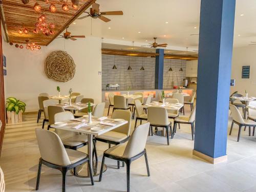 a dining room with tables and chairs in a restaurant at Sky Beach Maldives - Dhiffushi in Dhiffushi