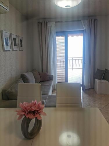 a living room with a table with a flower on it at Apartment Bellavita Senj in Senj