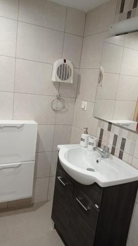 a bathroom with a sink and a mirror at VillaTzer - Traditional house with fireplace and garden in Tzermiádon
