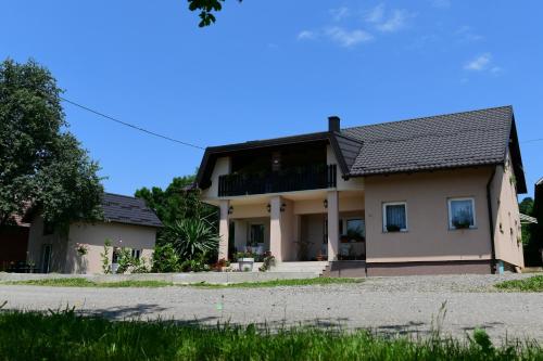 a house with a balcony on the side of it at Apartments Green Linden in Rakovica