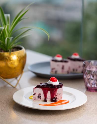 a piece of cake on a plate on a table at The Oasis Mussoorie - A Member of Radisson Individuals in Mussoorie