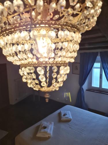a chandelier hanging over a table in a room at dalla fortezza al mare - la vostra casa a San Leo in San Leo