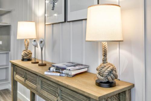 a room with two lamps on a table with books at Yacht Park Marina by AmberBlue in Gdynia