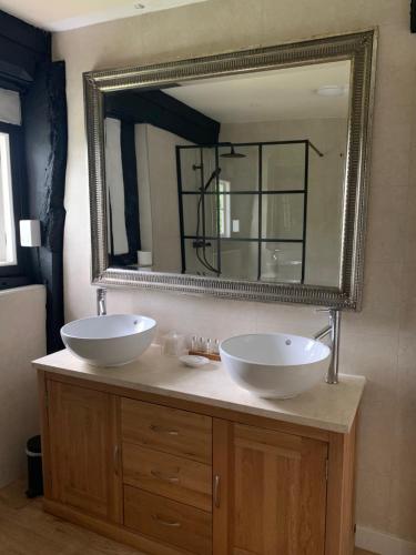 a bathroom with two sinks and a large mirror at Rhydspence in Hay-on-Wye