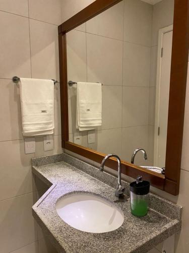 a bathroom with a sink and a mirror at Vg Sun Cumbuco C5 106 in Caucaia