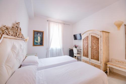 En eller flere senge i et værelse på Residenza Due Torri check in presso HOTEL CENTRALE Vicolo Cattani 7