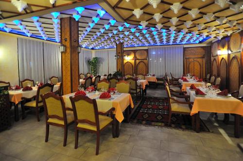 a restaurant with tables and chairs and people sitting at them at Boutique Hotel Old Town Mostar in Mostar