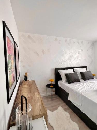 a bedroom with a bed and a wooden table at Apartmani CUBE A in Medulin