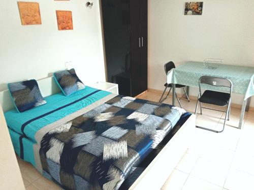 Aldeia das Açoteias, Apartment, WI-FI, في ألبوفيرا: غرفة نوم بسرير وطاولة مع كراسي