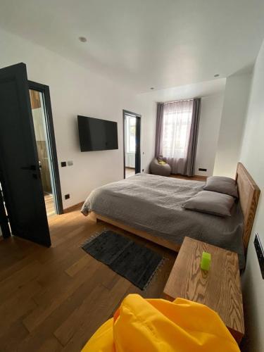 a bedroom with a bed and a tv on the wall at Riverside in Slavske