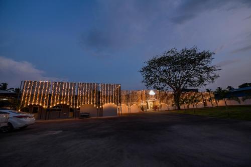 a building with christmas lights on it at night at Shine Residency in Mysore